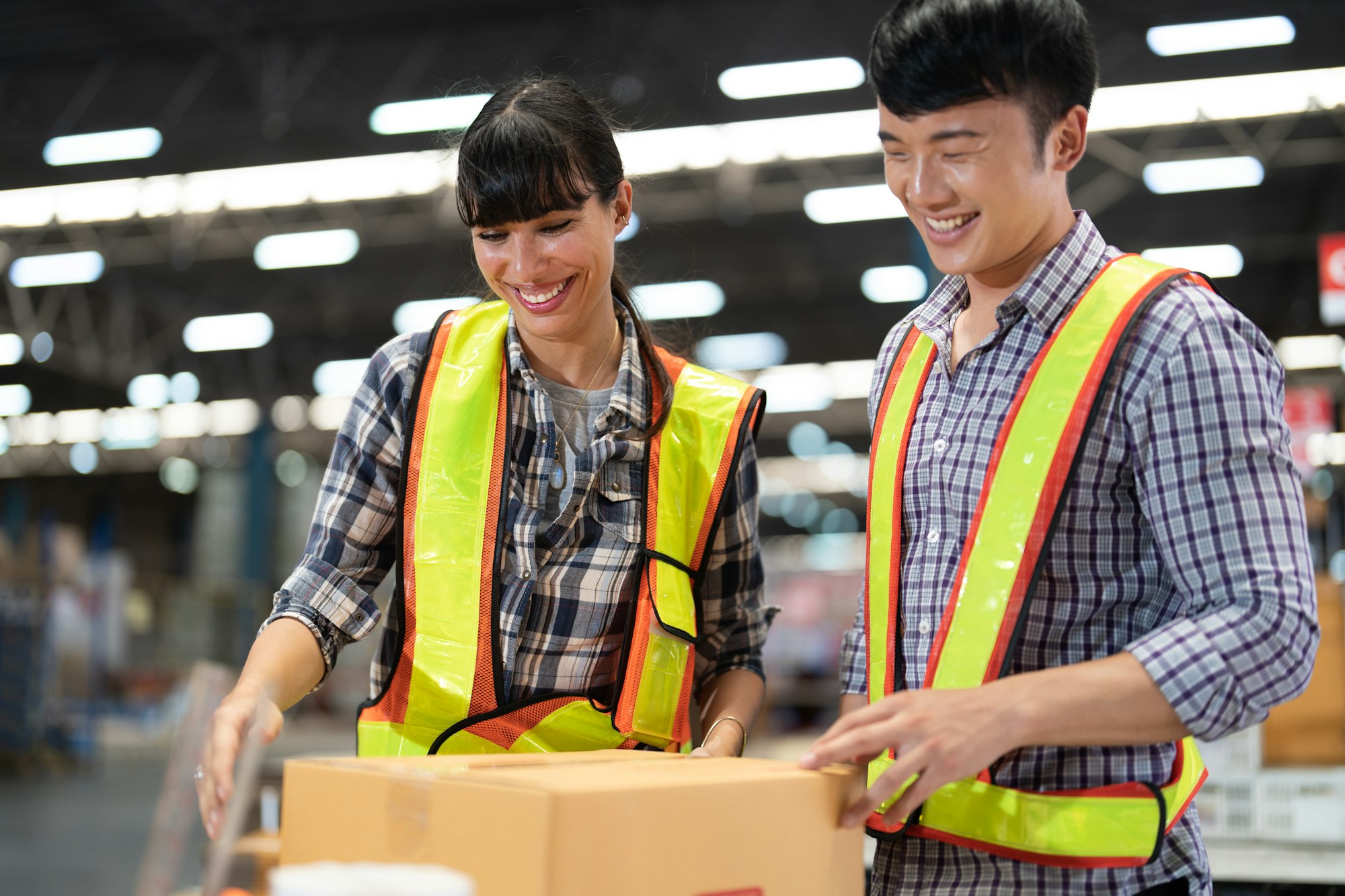 2 staff worker working in the large depot storage warehouse