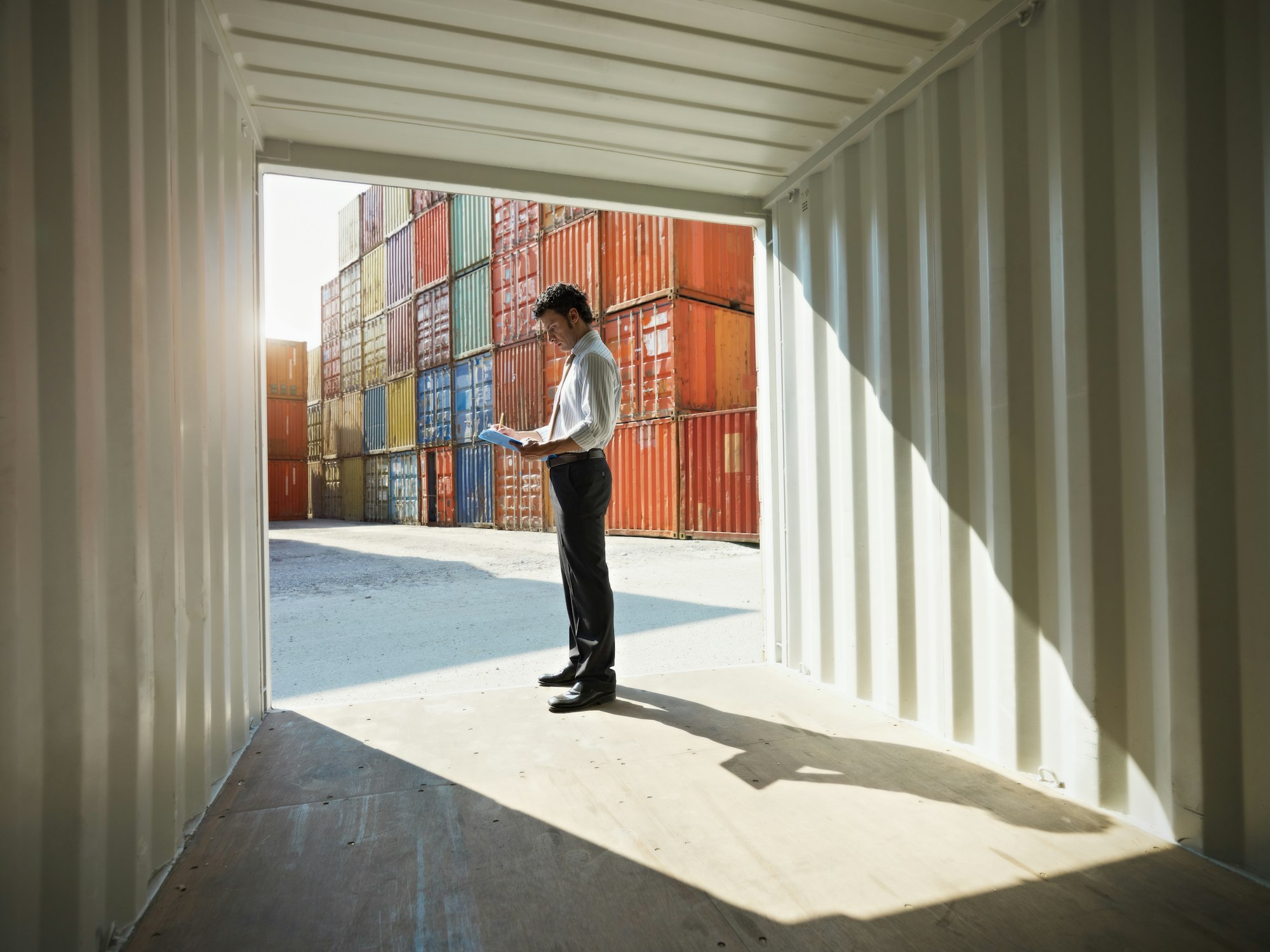 business man with shipping containers